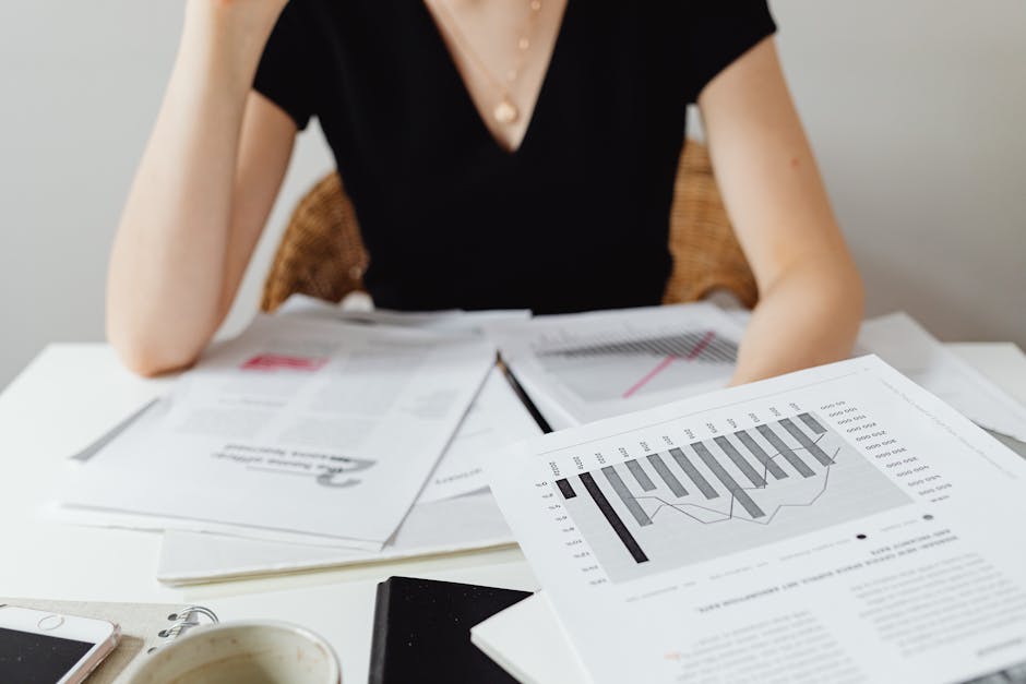 Close-up of financial documents and graphs on a desk, showcasing business analysis.